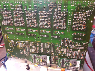 This is the bottom of the Siemens gate driver board: you can see the six drivers at the top. At the bottom, the two small PCBs are current sensor boards. I think the flat cables lead to the actual sensors, hidden in the white block at the bottom.